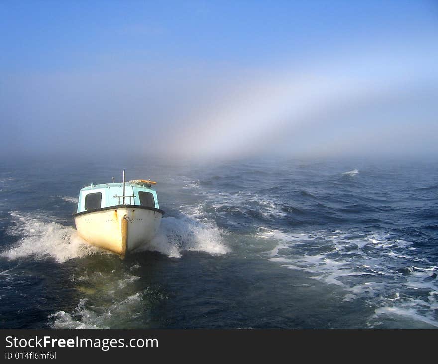 Sea, boat and rainbow