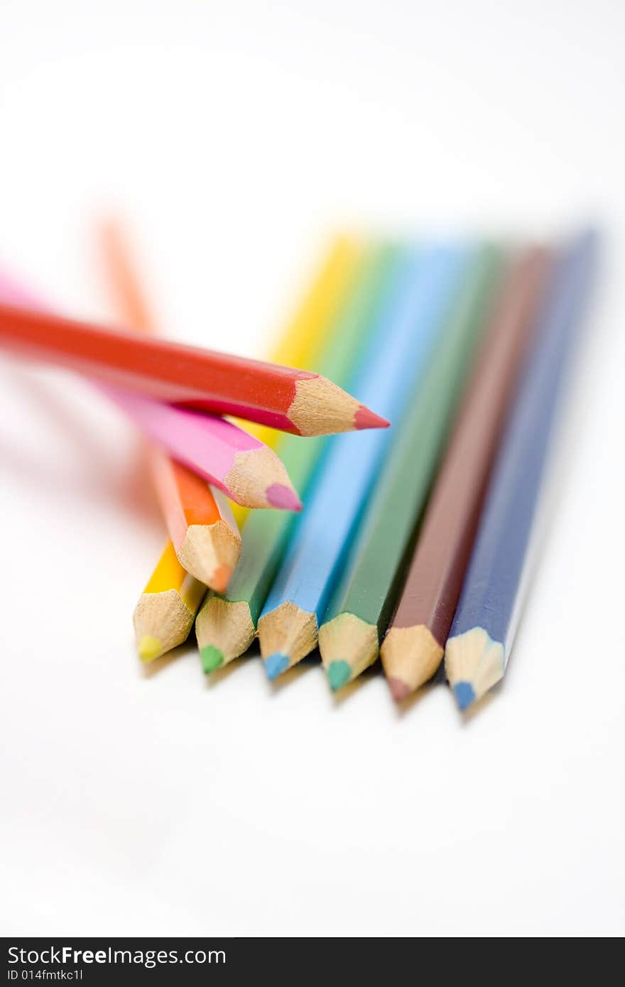 Color pencils in arrange in color wheel colors on white background