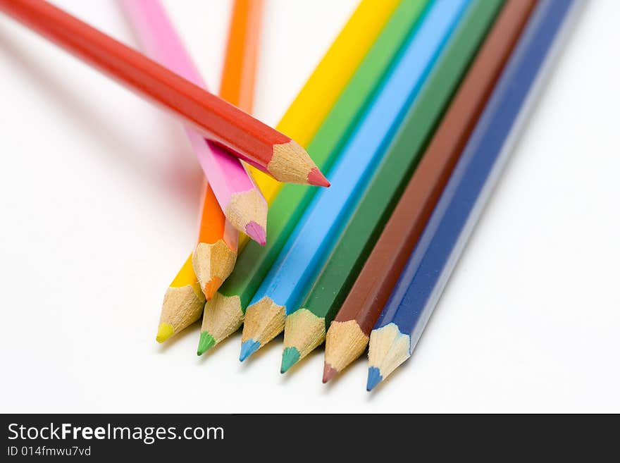 Color pencils in arrange in color wheel colors on white background