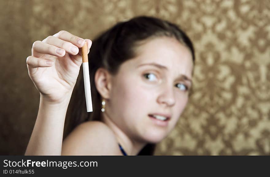 Young girl with a cigarette showing disgust. Young girl with a cigarette showing disgust