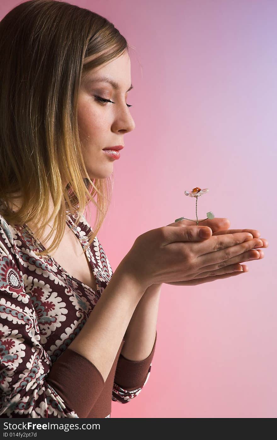 The girl with a flower in palms