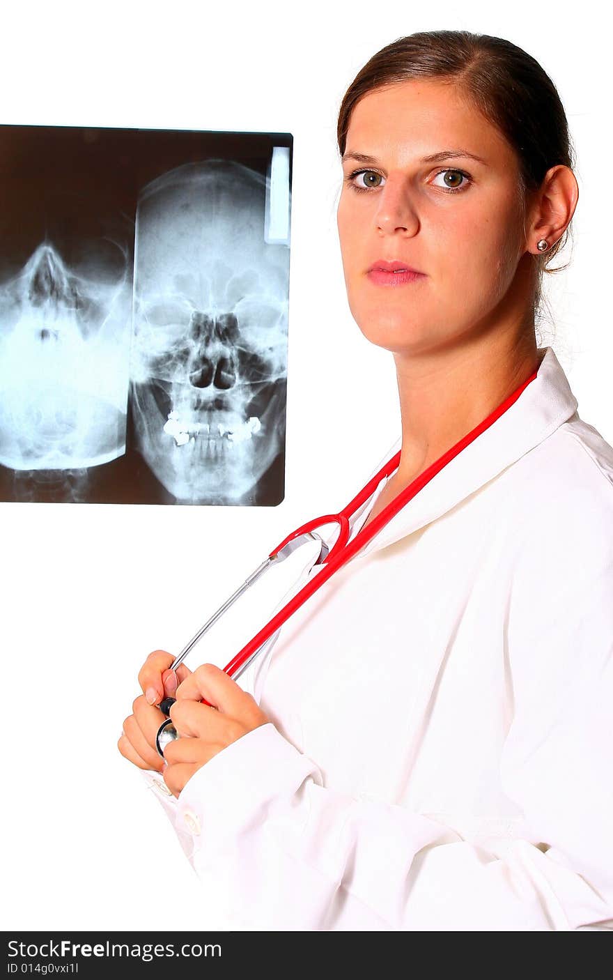 A beautiful young doctor with a red stethoscope and a xray image in the back. Isolated over white. A beautiful young doctor with a red stethoscope and a xray image in the back. Isolated over white.