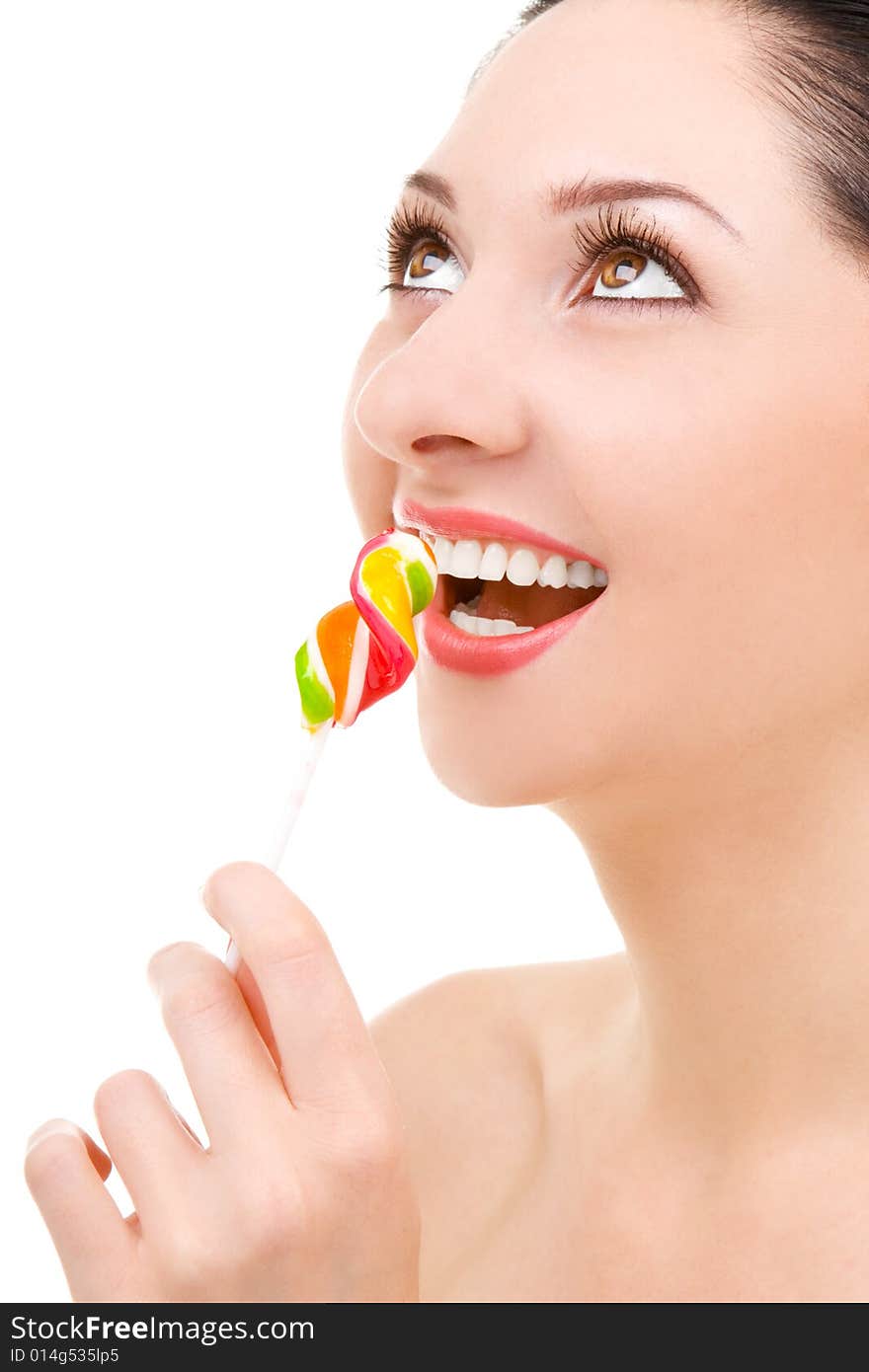 Pretty woman licking candy on white background