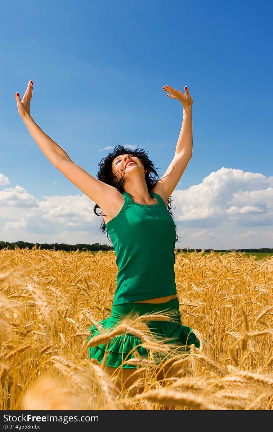 Woman jumping in golden wheat