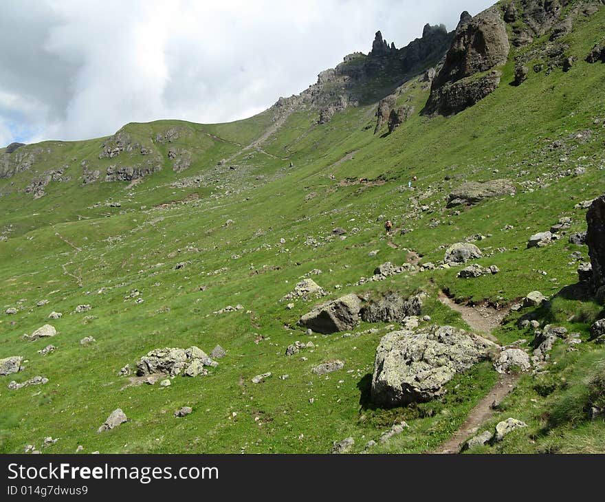 High mountain field with rocks