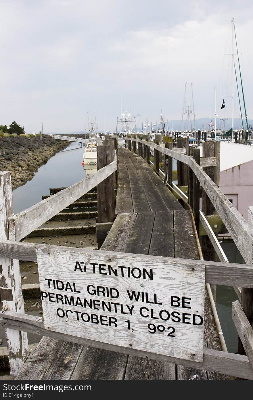 An old pier at a fishing harbor closed and broken. An old pier at a fishing harbor closed and broken