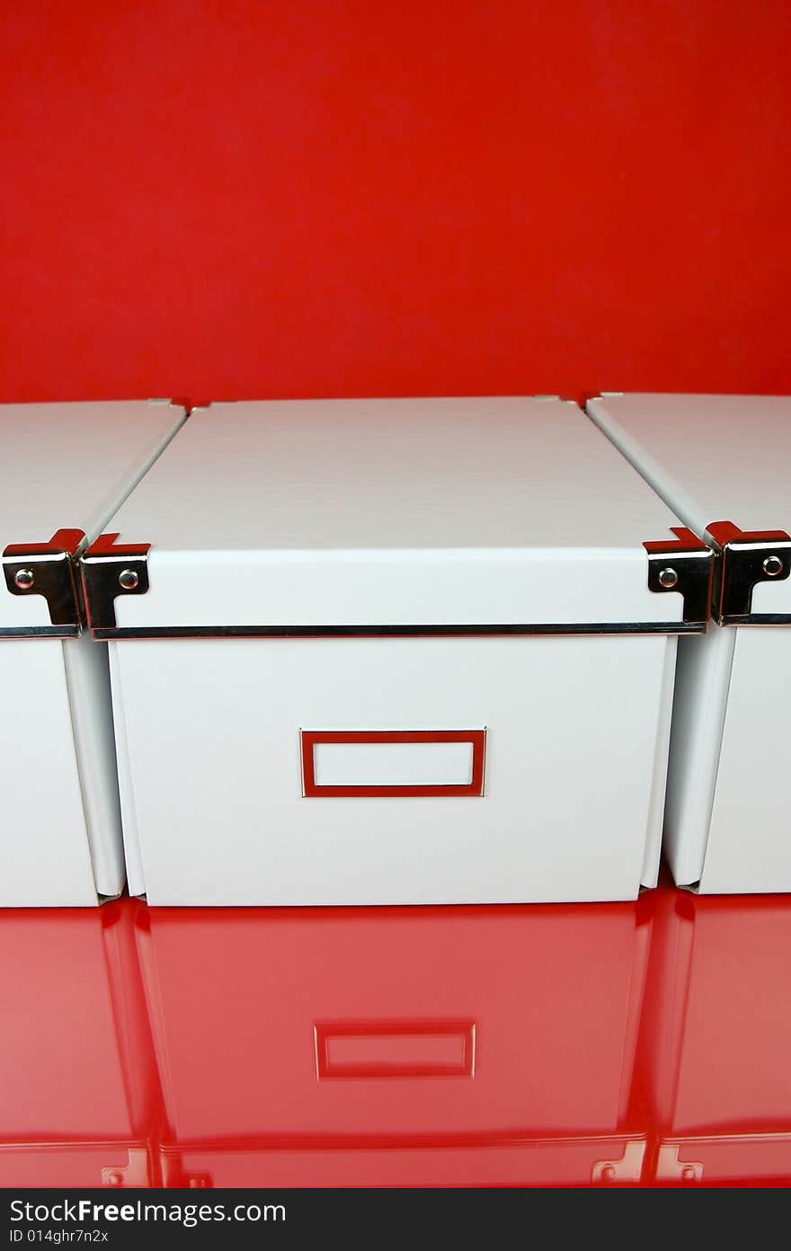 Storage boxes isolated against a red background