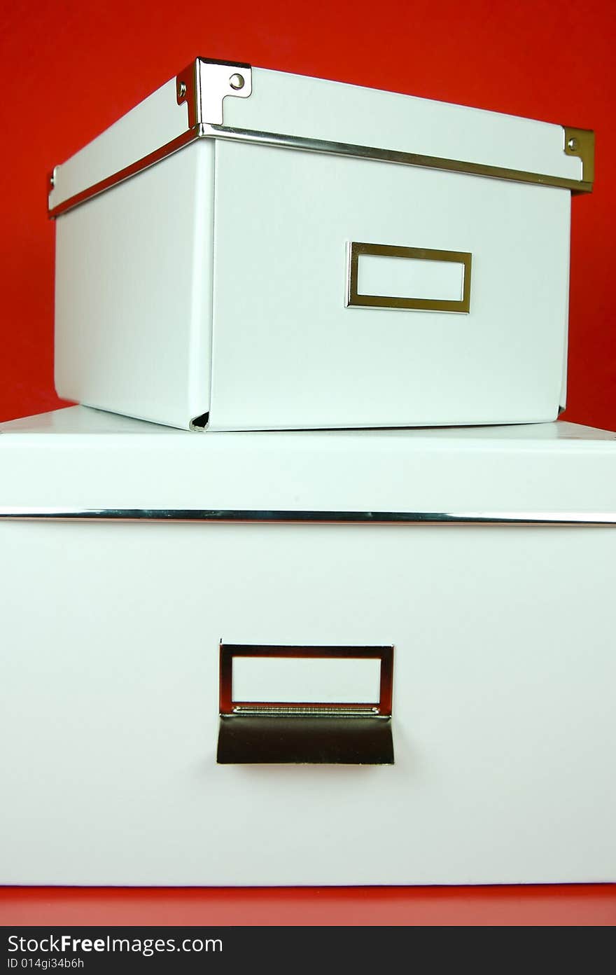 Storage boxes isolated against a red background