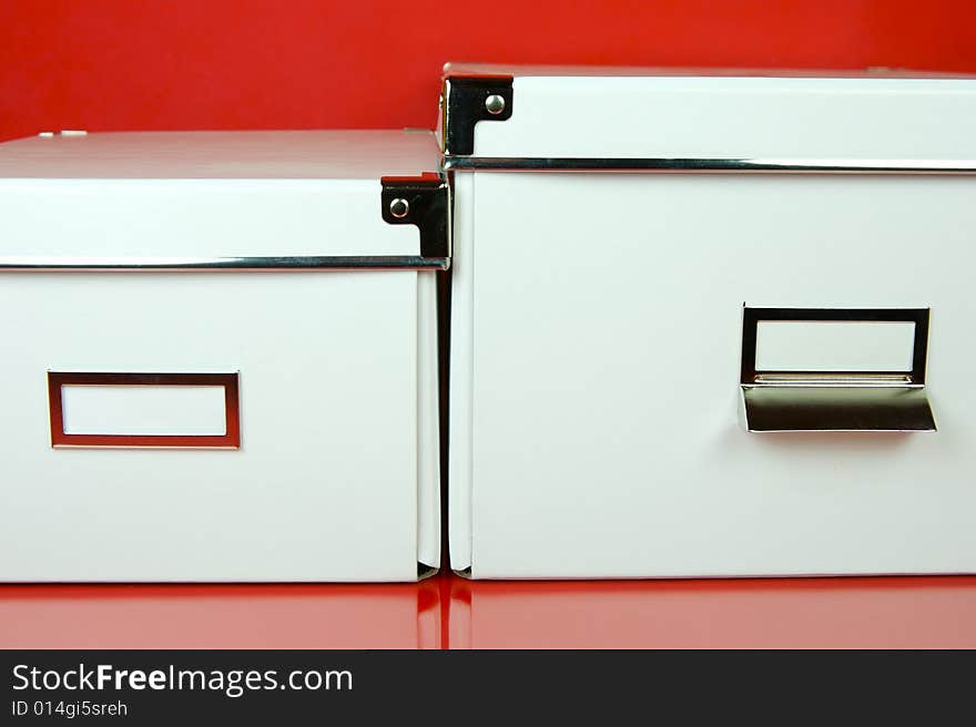 Storage boxes isolated against a red background