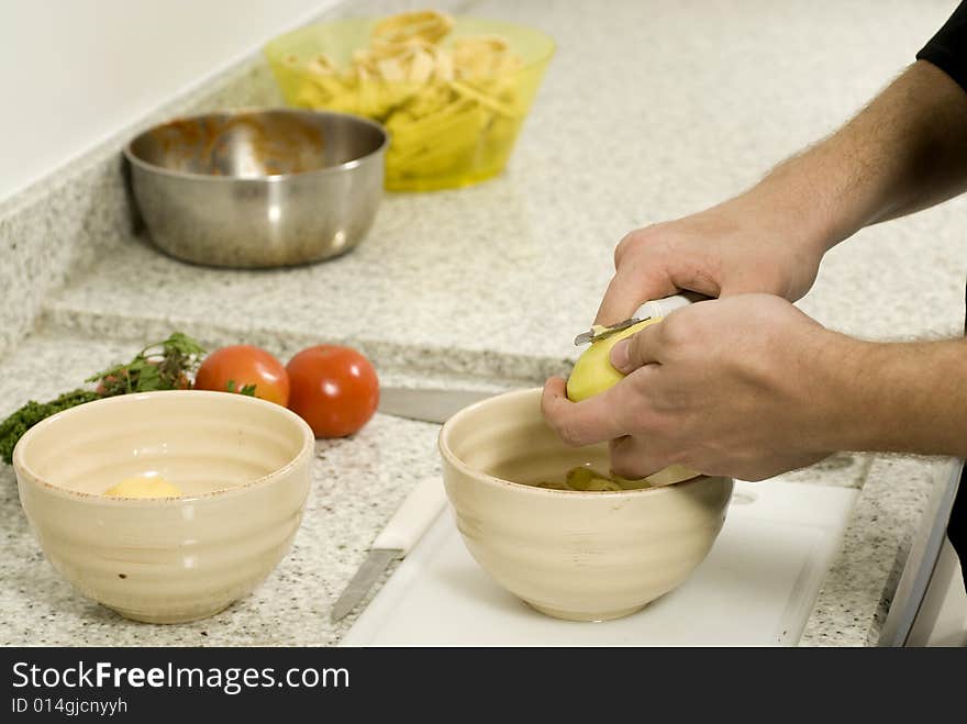 Hands Peeling Potatoes