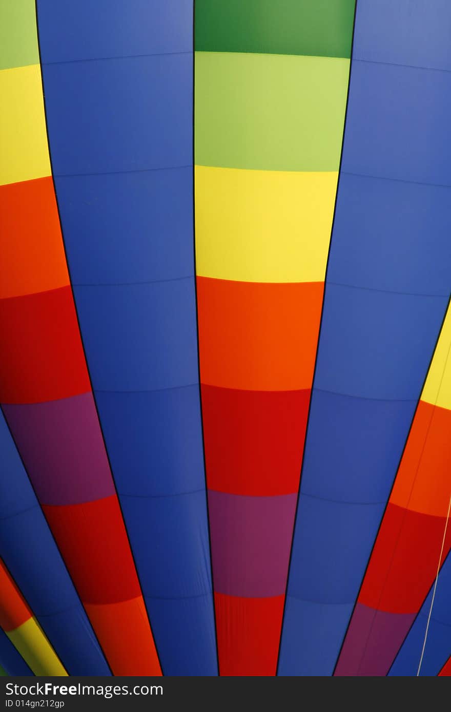 A colorful rainbow colored hot air balloon at the annual Kannapolis, North Carolina Hot Air Balloon festival. A colorful rainbow colored hot air balloon at the annual Kannapolis, North Carolina Hot Air Balloon festival