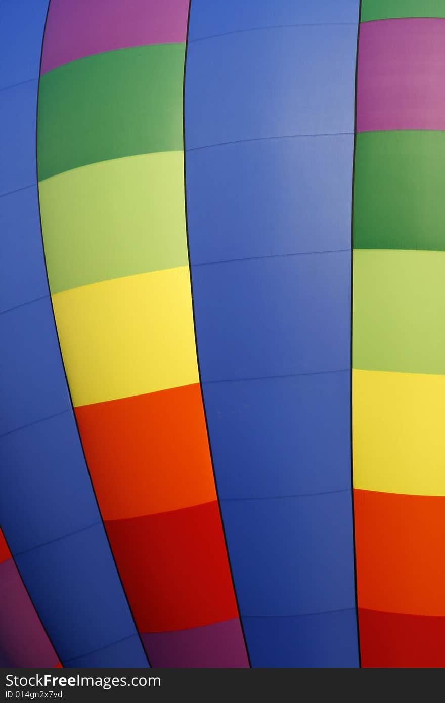 A colorful rainbow colored hot air balloon at the annual Kannapolis, North Carolina Hot Air Balloon festival. A colorful rainbow colored hot air balloon at the annual Kannapolis, North Carolina Hot Air Balloon festival