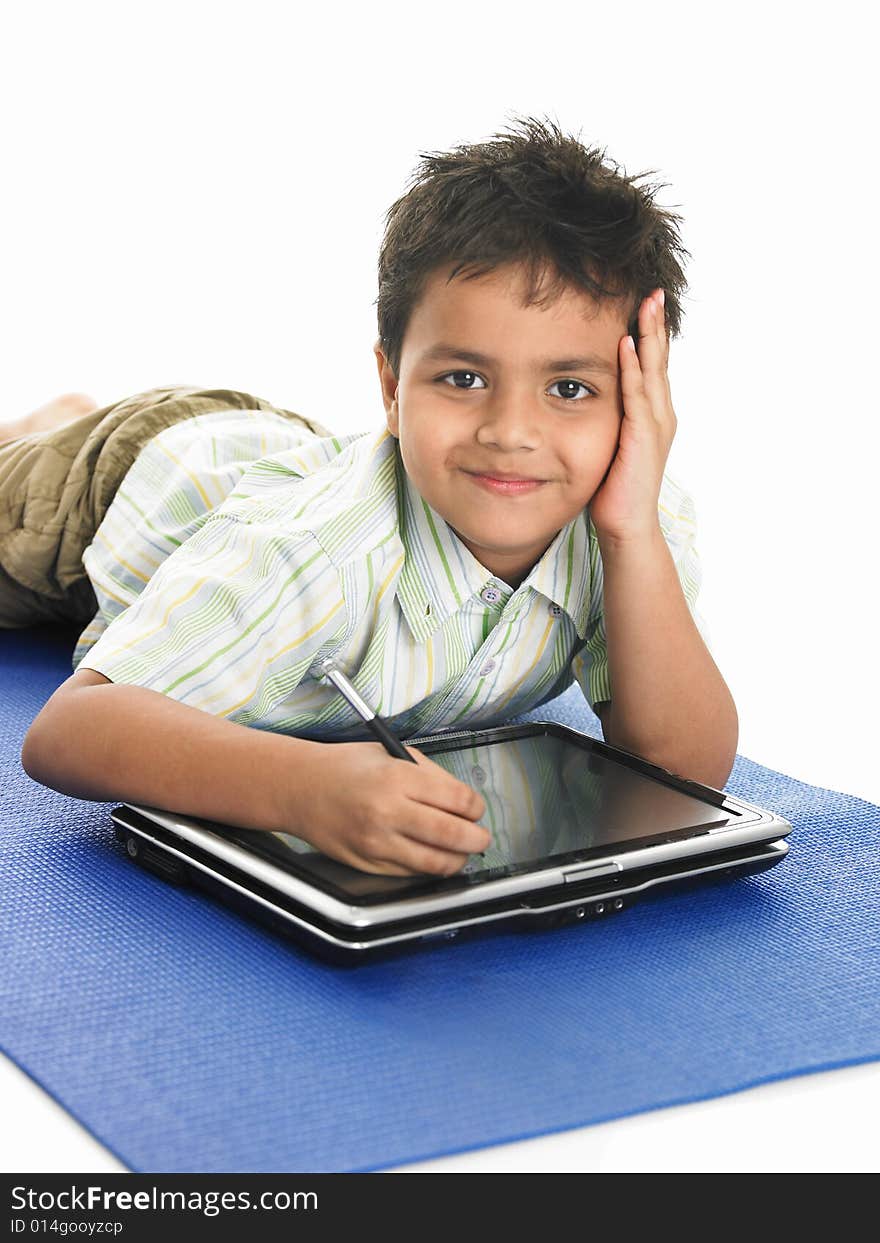 Asian boy of indian origin with a laptop. Asian boy of indian origin with a laptop