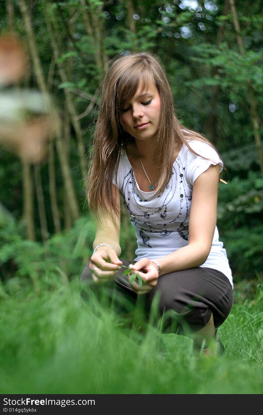 Photo present a girl holding leaves in hands. Photo present a girl holding leaves in hands