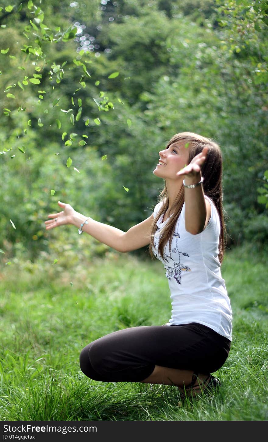 A Portrait Of A Gorgeous Girl Throwing Away Leaves