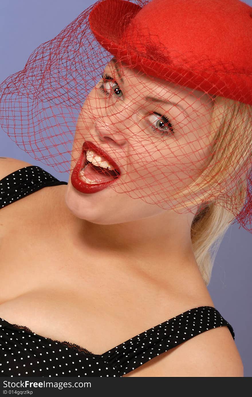 Excited blond girl in red hat