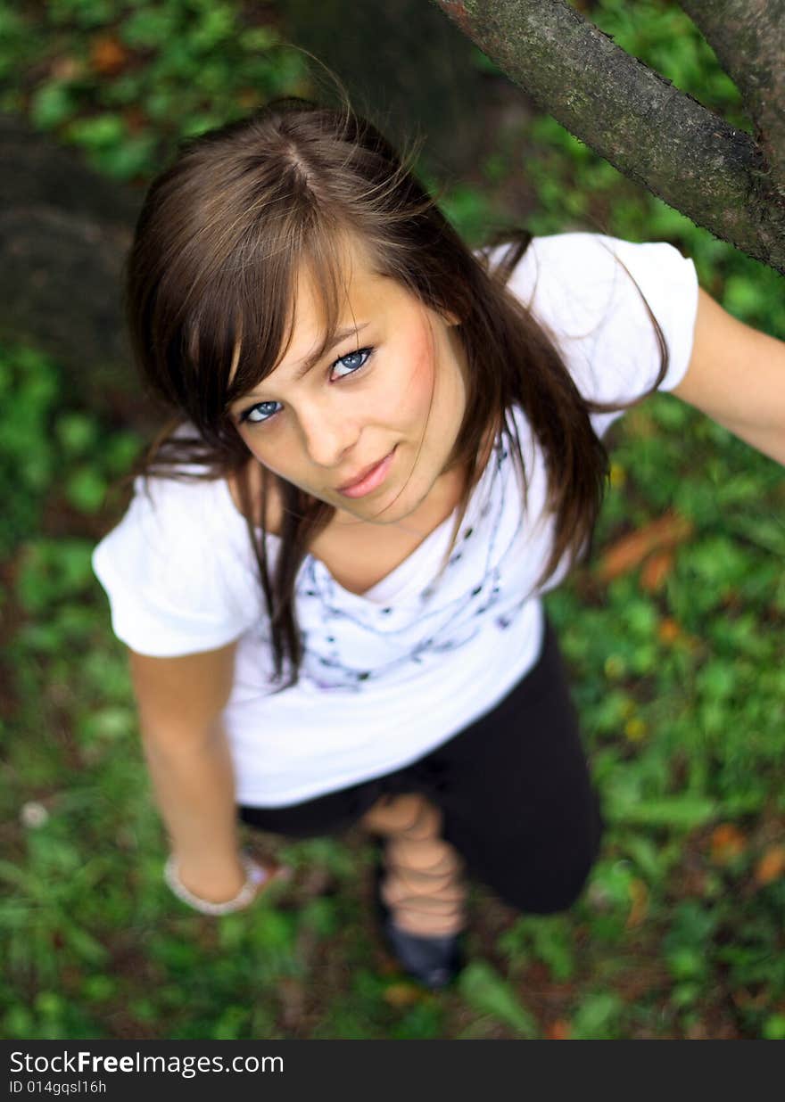 Young pretty girl smiling on the grass.