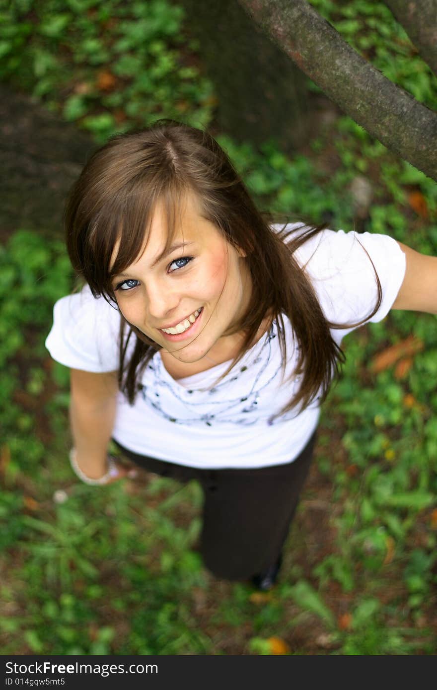 Young pretty girl smiling on the grass.