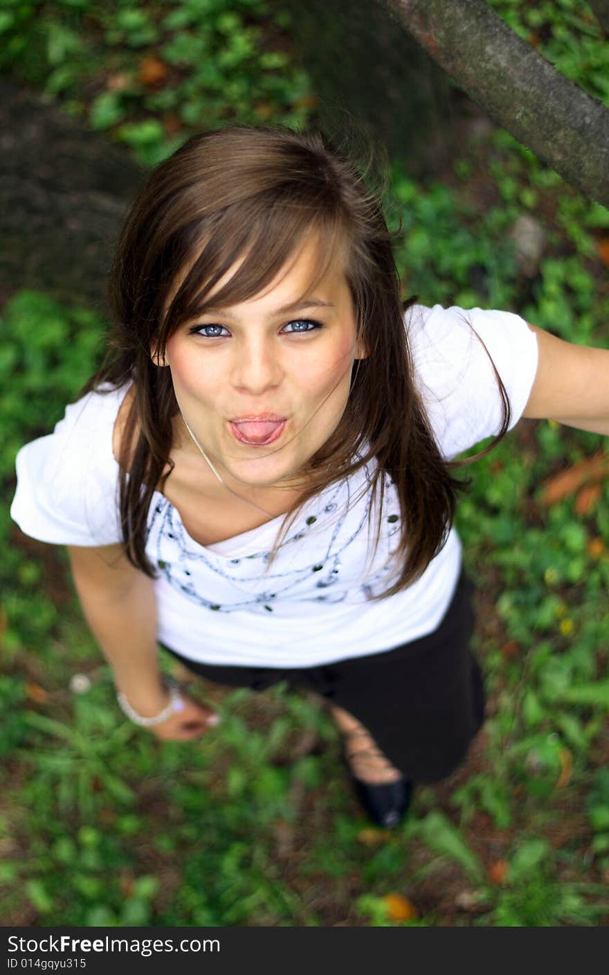 Young pretty girl smiling on the grass.