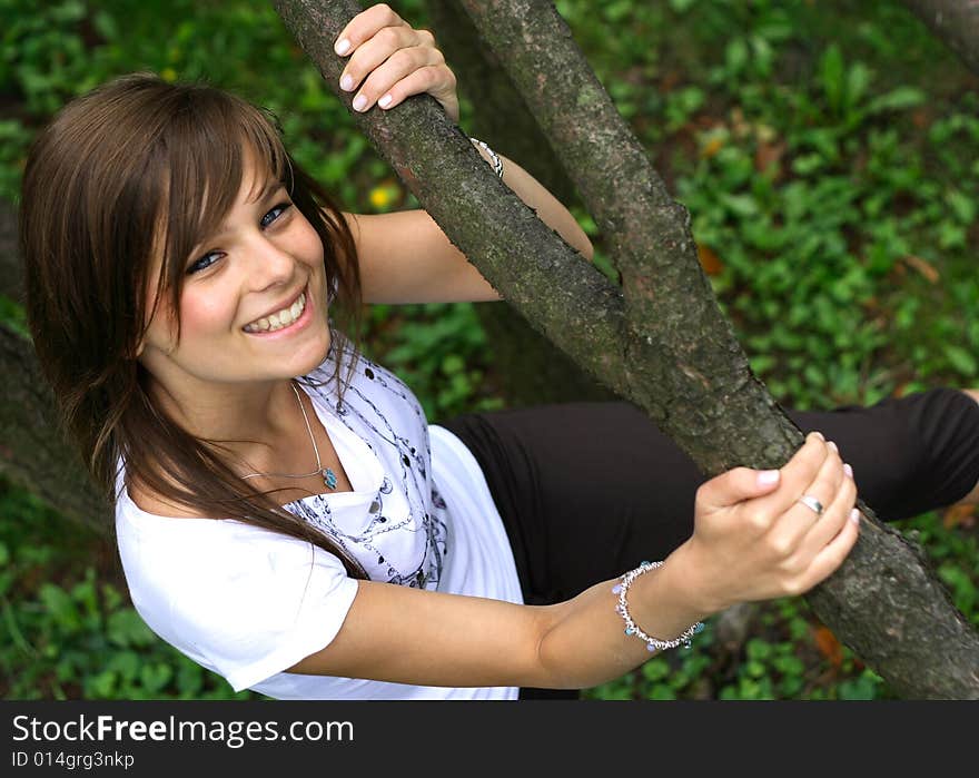 Young pretty girl smiling  on the grass.