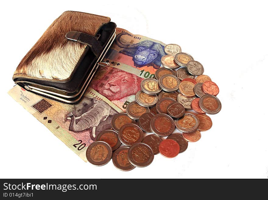 South African banknotes and coins with springbok skin purse, isolated against white. South African banknotes and coins with springbok skin purse, isolated against white