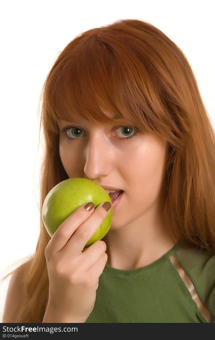 Red-haired girl eating green apple isolated on white background. Red-haired girl eating green apple isolated on white background