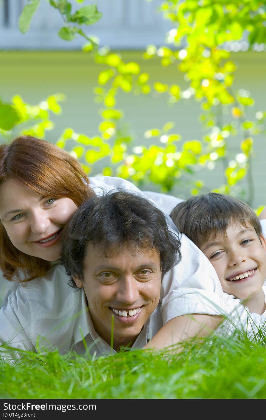 Portrait of young happy family in summer environment. Portrait of young happy family in summer environment