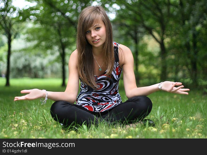 Young pretty girl with the apples on the grass