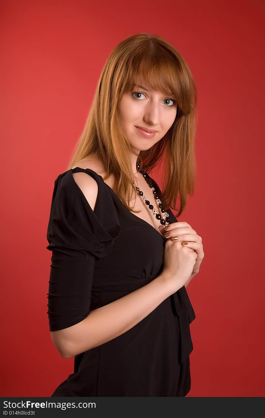 Sensual girl with necklace isolated on red background