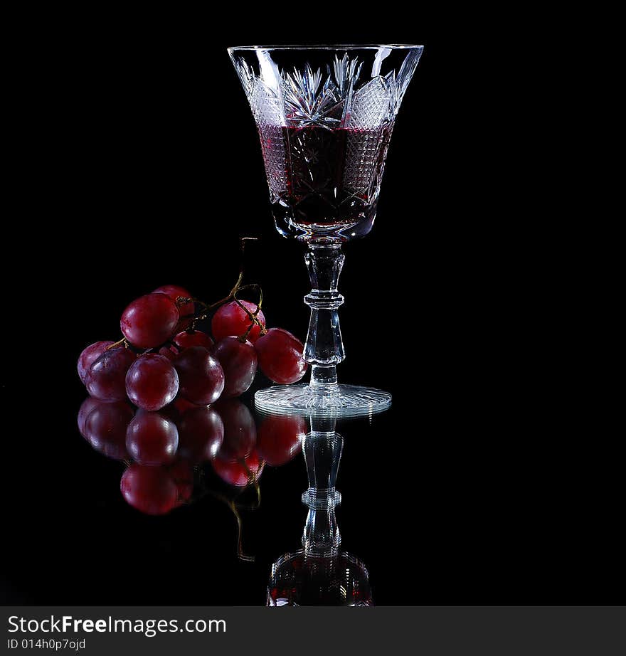 Red wine with red grapes