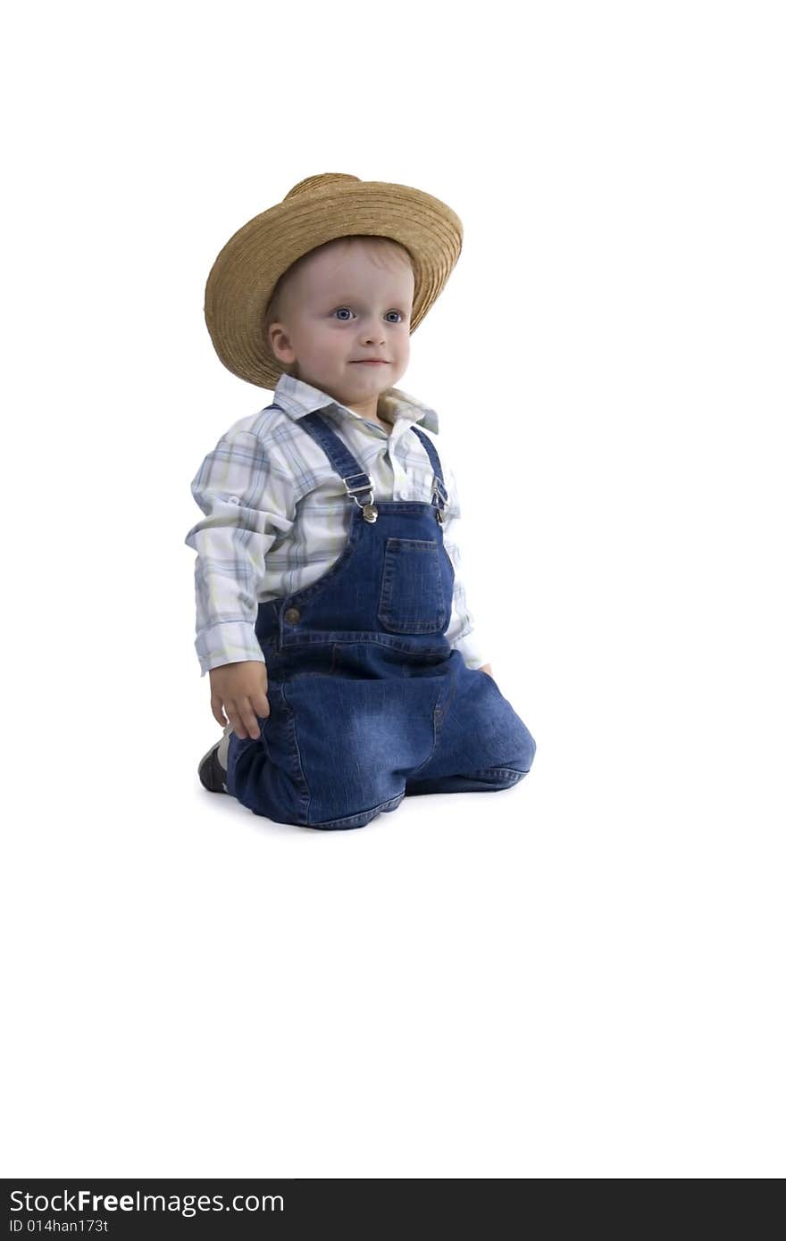 Sitting boy with straw hat on egg white background