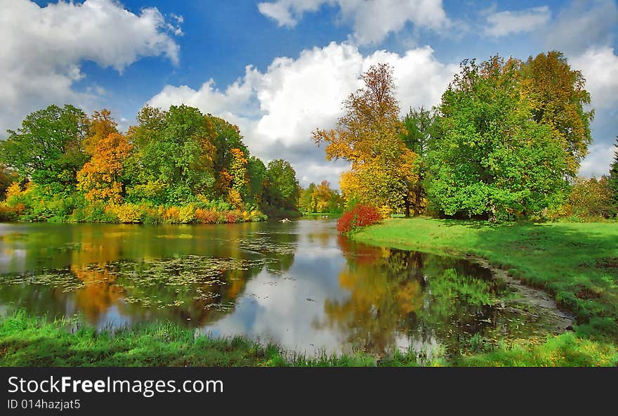 Bright autumn trees and boats in the park. Bright autumn trees and boats in the park