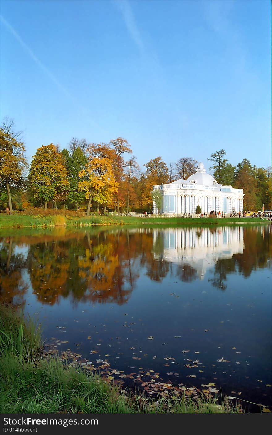 Classical building near the pond in autumn day vertical. Classical building near the pond in autumn day vertical