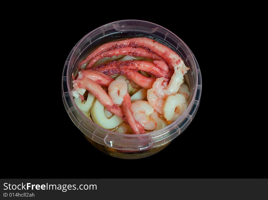 Seafood cocktail. mussels, octopus and calamary in plastics-ware on black background.