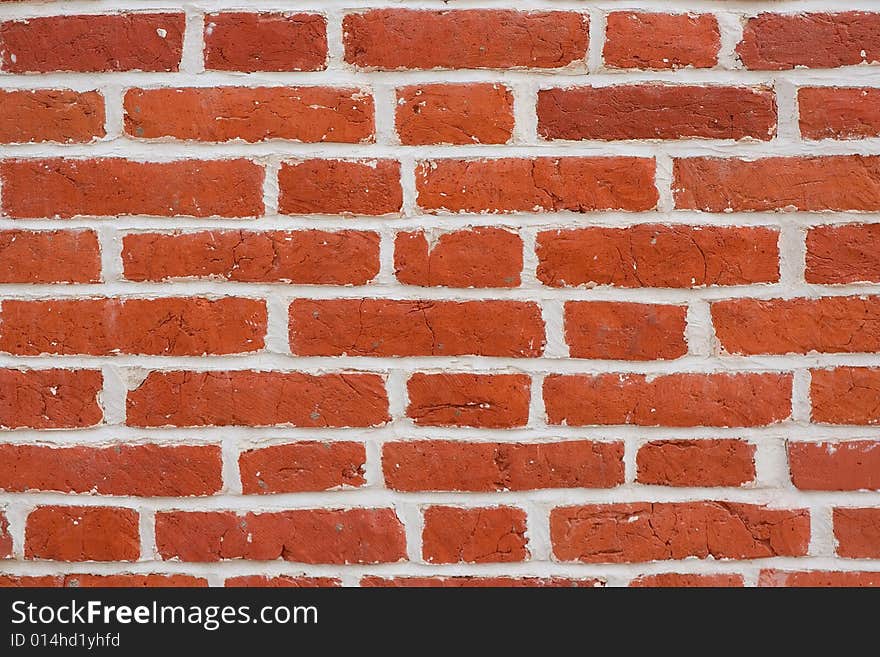 A pattern of red rectangular natural brick textured blocks. A pattern of red rectangular natural brick textured blocks.