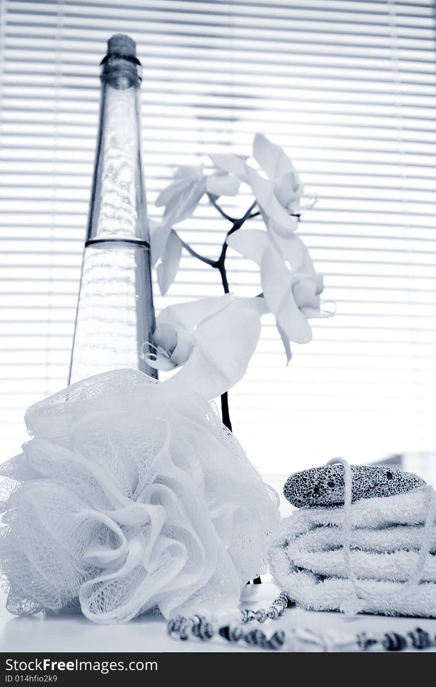 Monochrome bath background with orchid and bottle