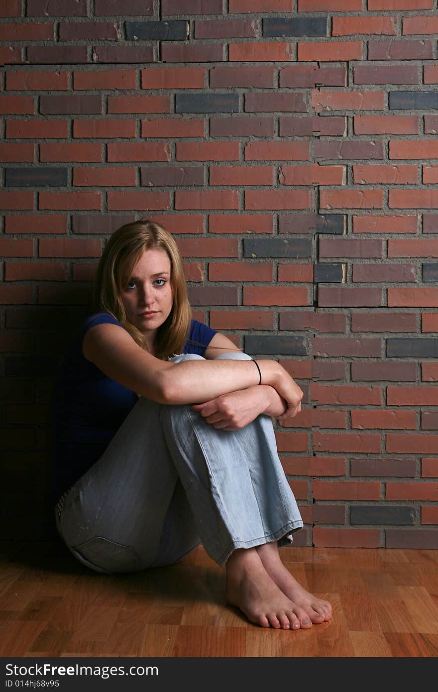 Woman sitting with knees up