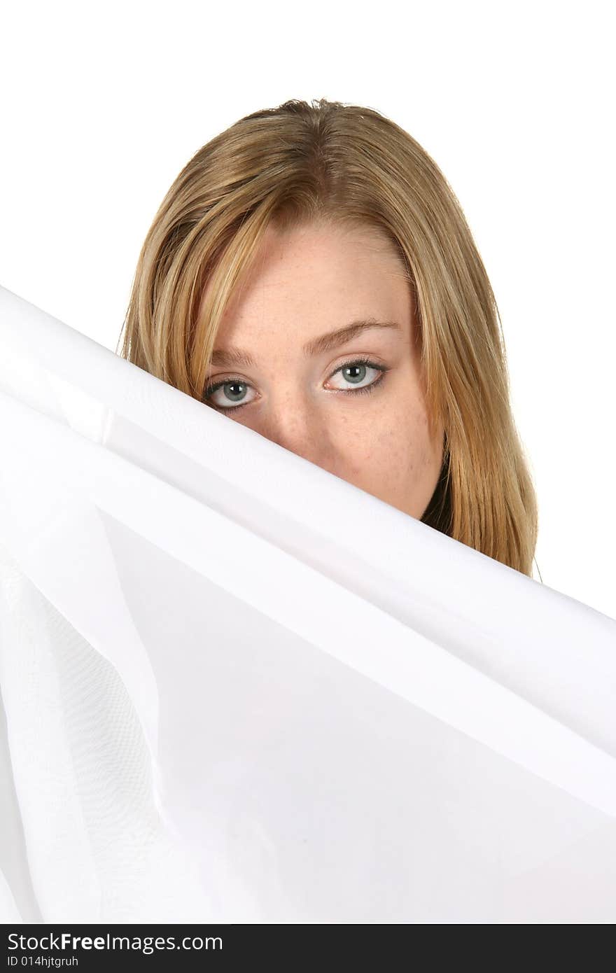 Woman looking over white pillow