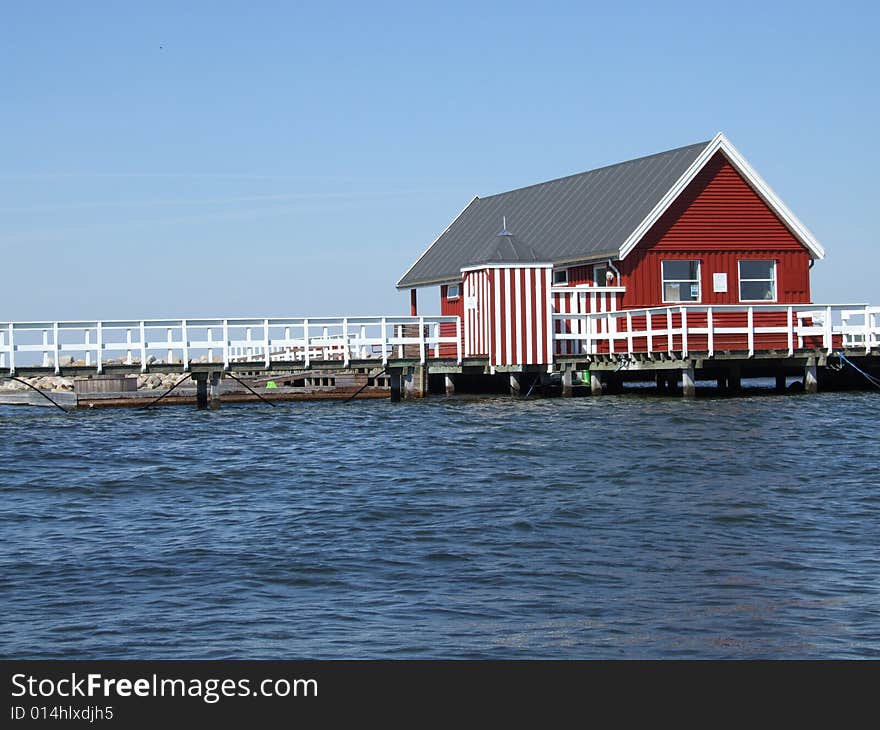 Red log cabine at sea side