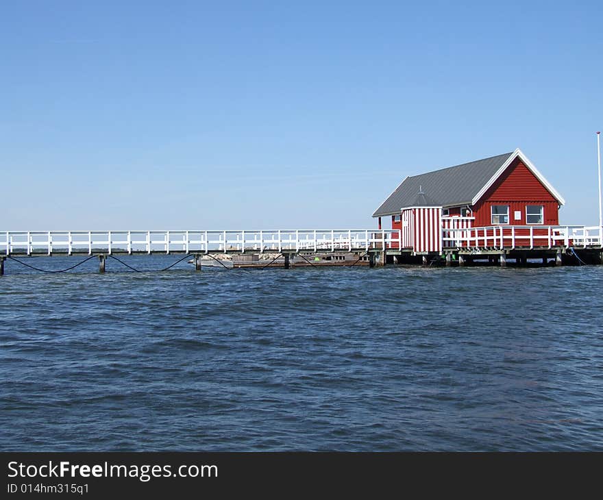 Red log cabine at sea side