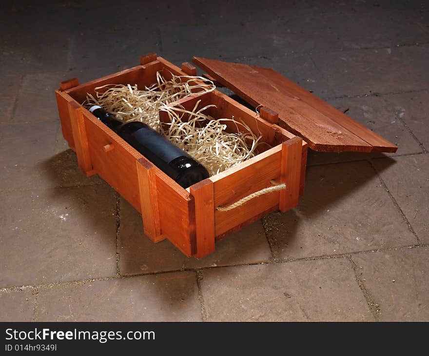 Old bottle of wine stored in wooden box. Old bottle of wine stored in wooden box