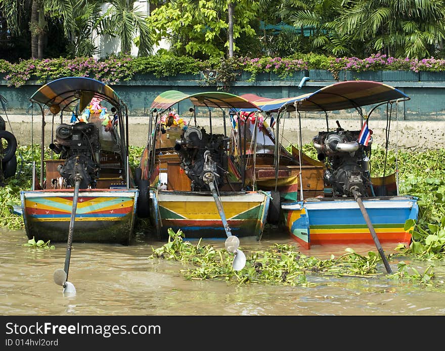 Three longtail riverboats in Bangkok