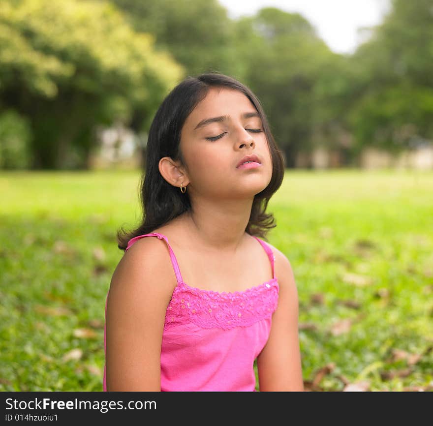 Asian girl relaxing in a park