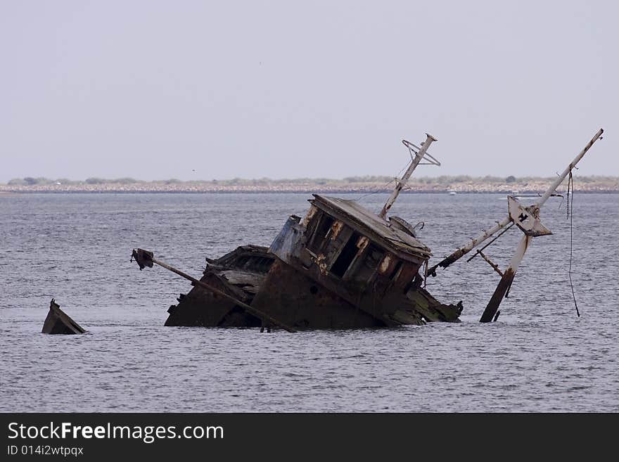 A stranded ship in the bay of ayamonte which is at the direct border between Spain and Portugal in Andalusia. A stranded ship in the bay of ayamonte which is at the direct border between Spain and Portugal in Andalusia.