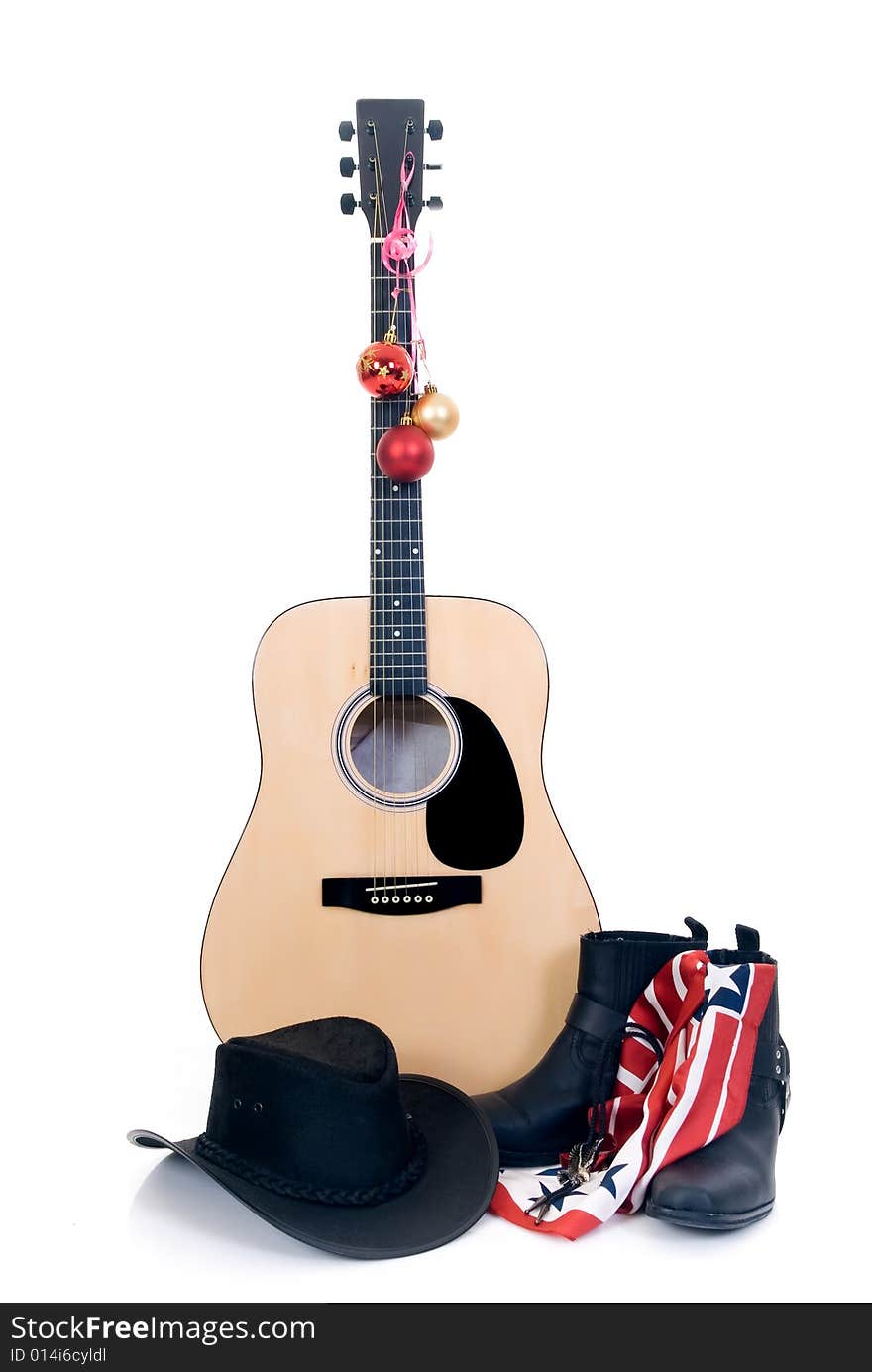 Guitar with cowboy hat and boots, decorated with Christmas balls, isolated on white background. Guitar with cowboy hat and boots, decorated with Christmas balls, isolated on white background