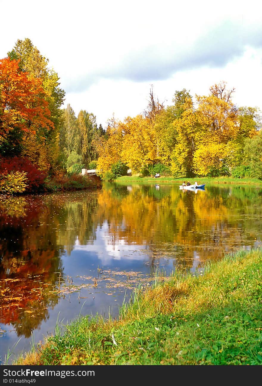 Picturesque pond with a boat in autumn day. Picturesque pond with a boat in autumn day