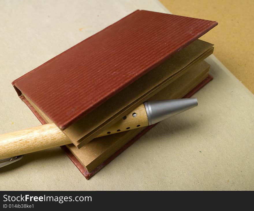 Pencil with small personal telephone register on a natural cardboard