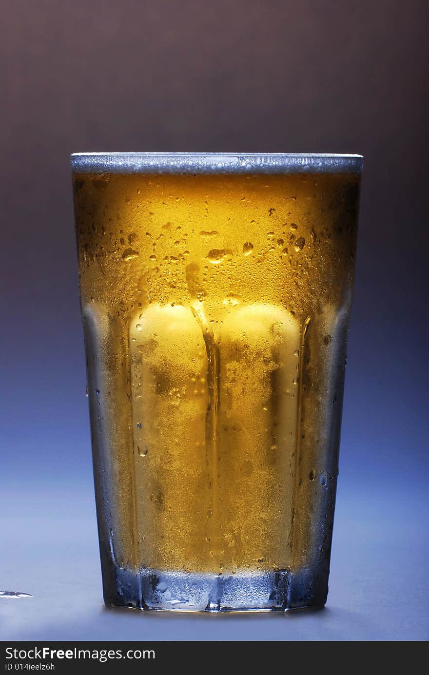 The glass full of beer on dark background