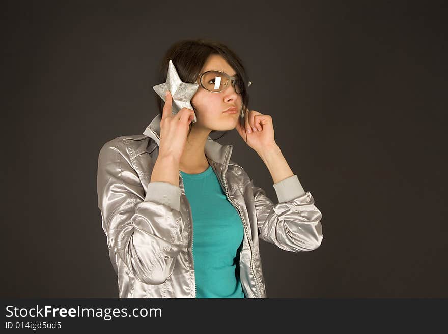 Fashion girl listening to stars isolated on black background