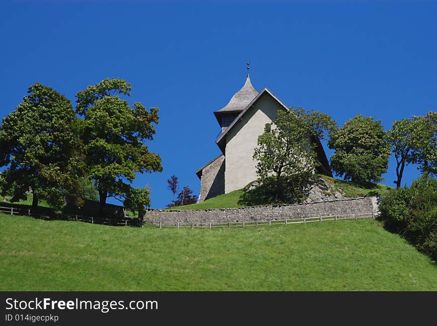 Old village church on green hill, horizontal. Old village church on green hill, horizontal